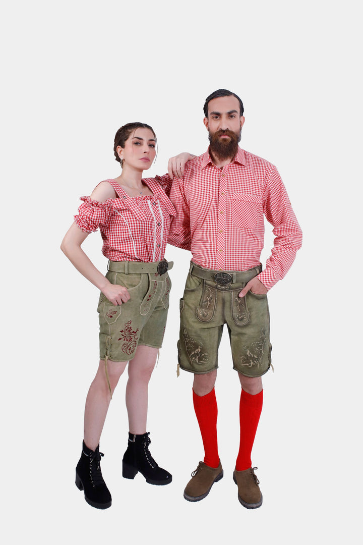 A couple wearing traditional German outfits. The woman is dressed in a red and white checkered off-shoulder top with Olive embroidered shorts. The man is in a matching red and white checkered shirt, olive embroidered shorts, red knee-high socks, and brown shoes. trachten outfit paar , partner outfit pärchen