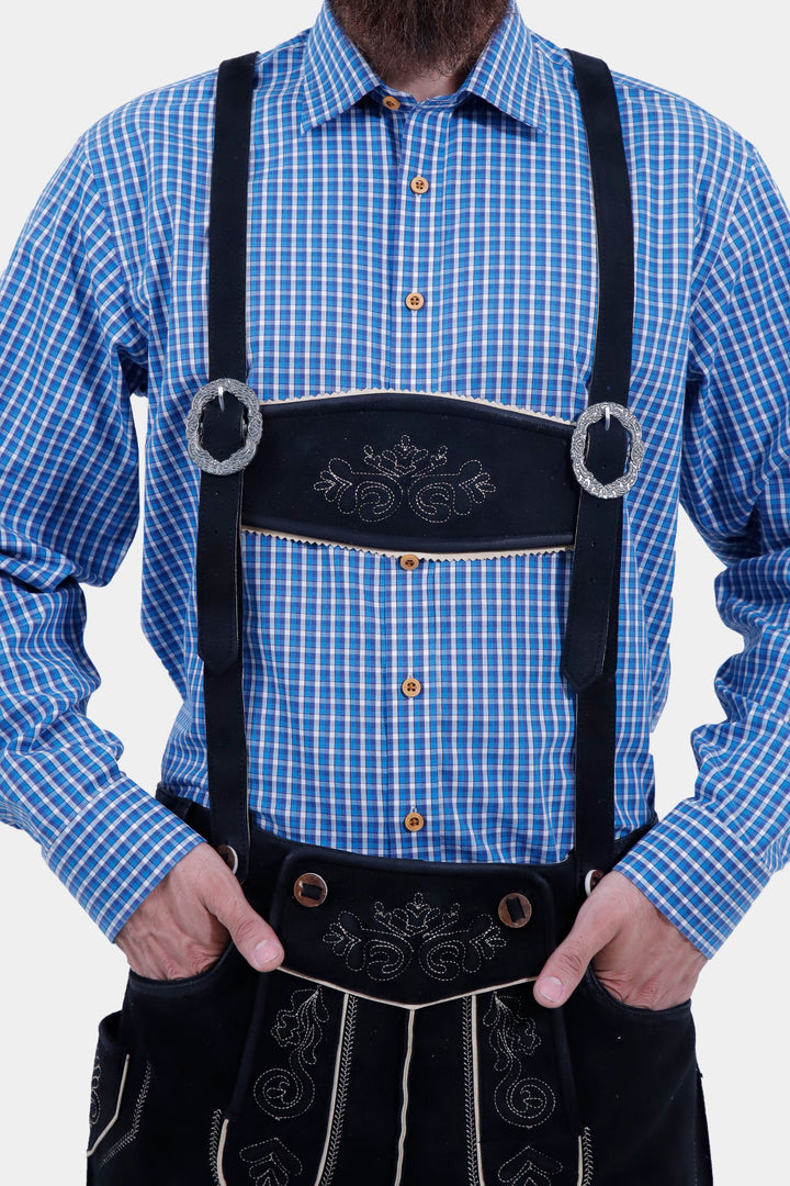 Close-up of the Bodensee Bundhosen with suspenders worn by a man with a blue checkered shirt, focusing on the embroidery and buckle details.