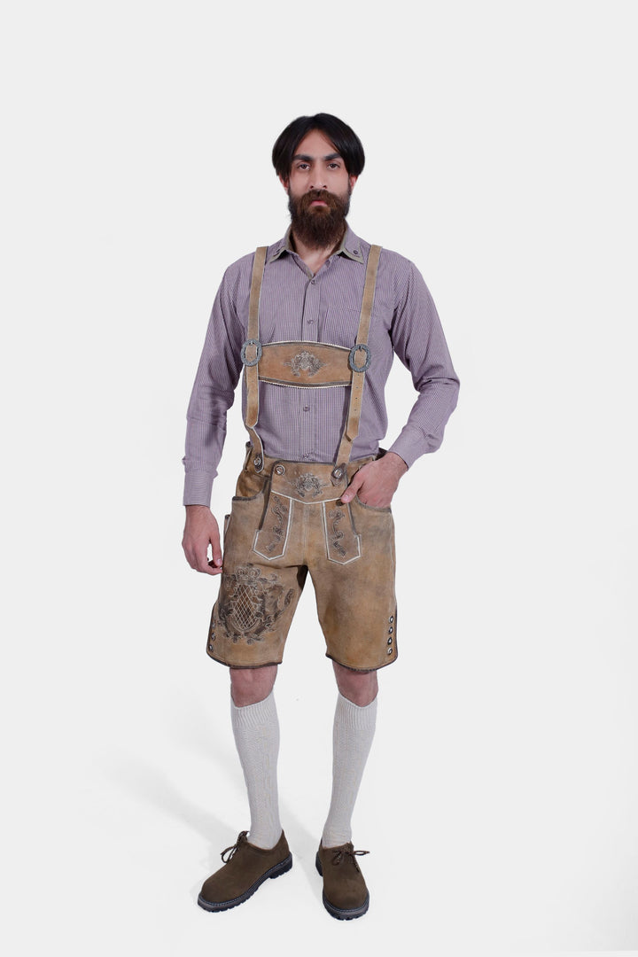 Man standing in Boris Becker Lederhosen with checkered shirt, dark brown shoes, and knee-high socks, full body shot.