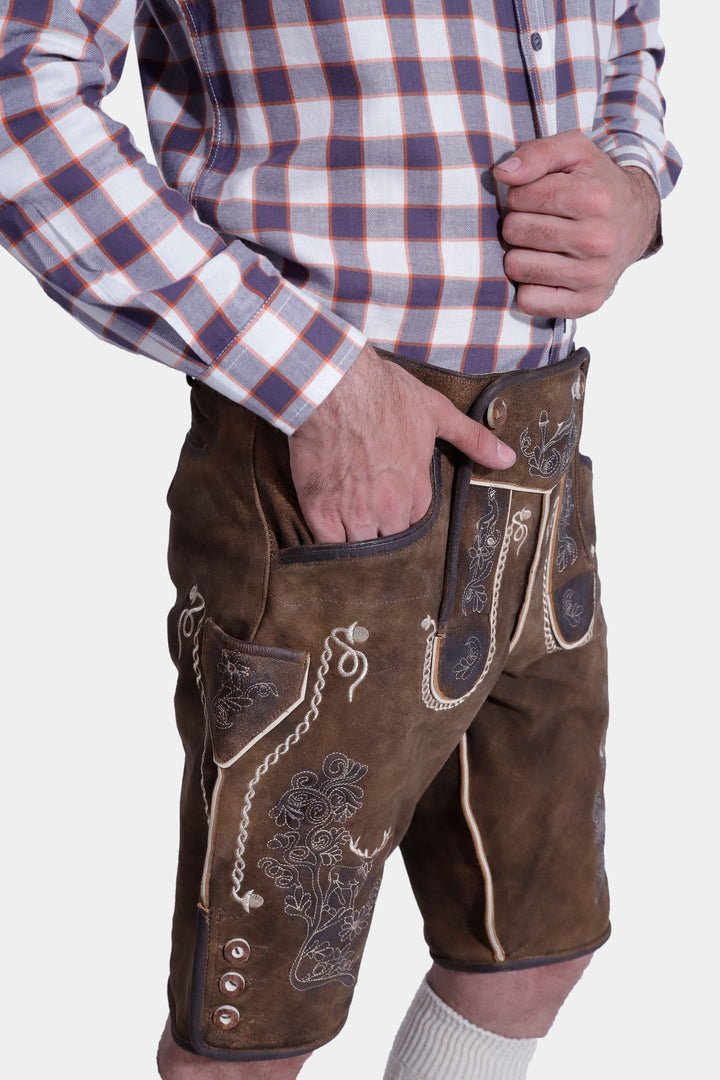 Close-up of "Chestnut Oak" lederhosen, showing intricate white embroidery and horn buttons.