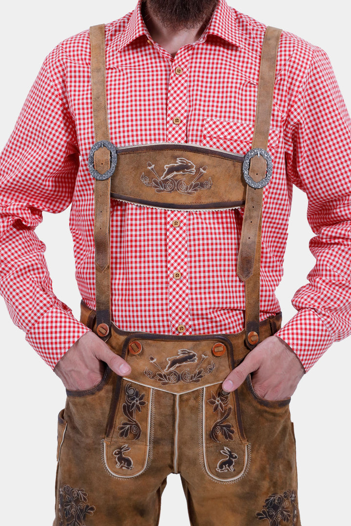 Close-up view of the Chiemsee Lederhosen suspenders, detailing the embroidered designs and the traditional style of the leather shorts.