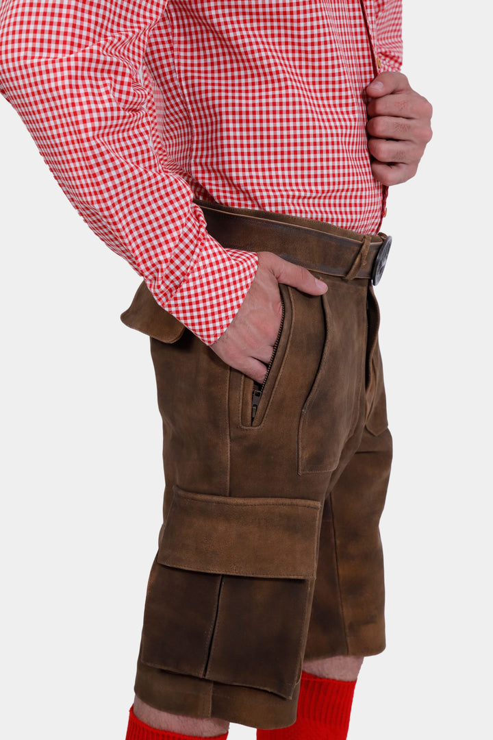 Side view of the DJ Ötzi Cargo Lederhosen, emphasizing the cargo pockets and quality of the leather, with a red checkered shirt.