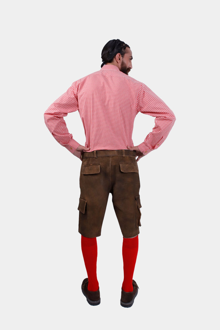 Rear view of a man in DJ Ötzi Cargo Lederhosen and a red checkered shirt, showing the back pockets and fit of the lederhosen.