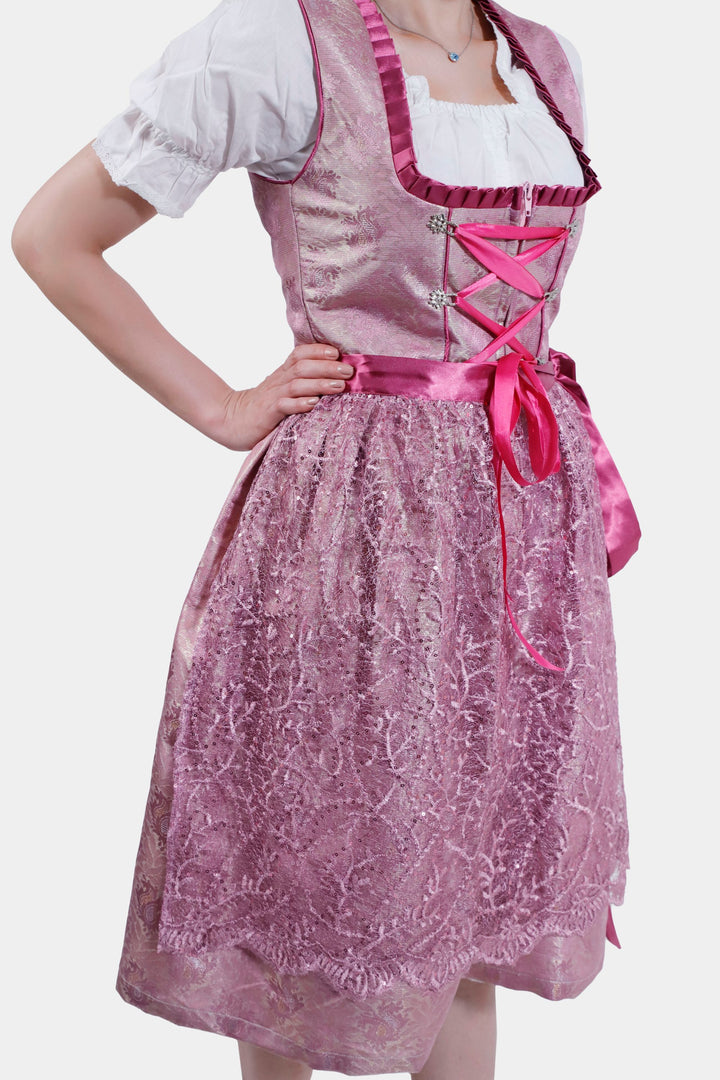 Side view of the Dirndl Christiane, focusing on the lace texture of the skirt and the neatly tied satin apron ribbon at the back.