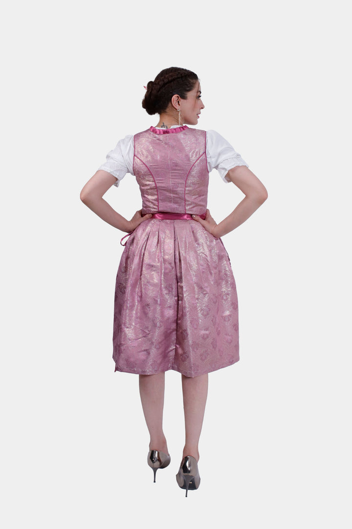 Back view of the Dirndl Christiane, focusing on the lace texture of the skirt and the neatly tied satin apron ribbon at the back.