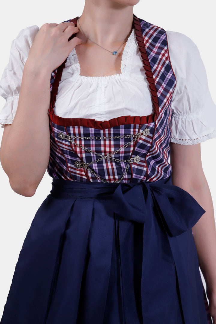 Close-up of the Dirndl Hilker bodice, displaying intricate plaid detailing and the elegant texture of the fabric.