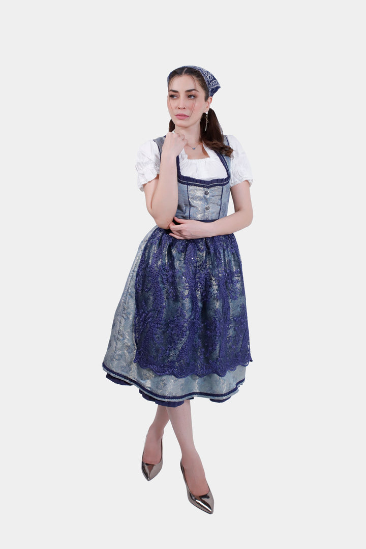 Full-length view of a woman wearing a Dirndl Maria Lara, showcasing the intricate lace detail and vibrant blue color.