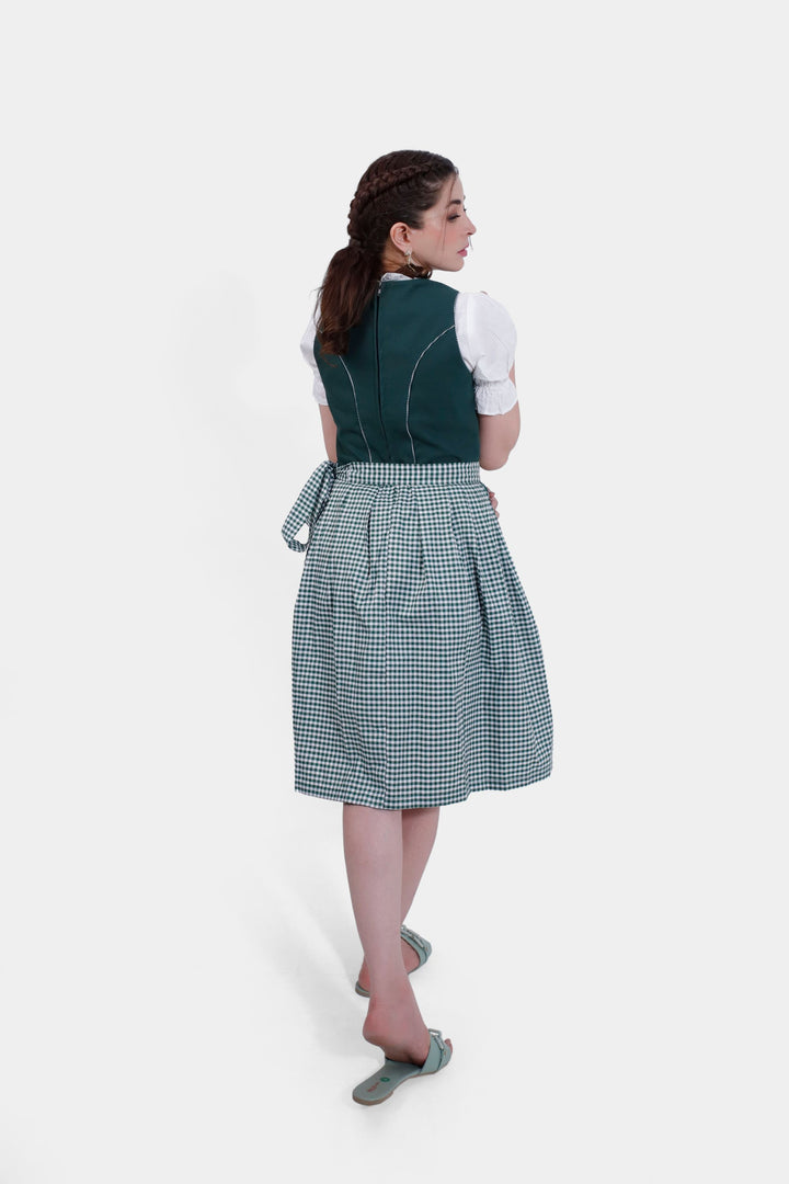 Back view of a woman wearing Dirndl Sukowa, showcasing the tied gingham apron and the detailed stitching on the green bodice.