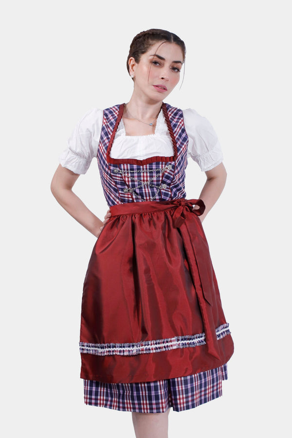 Woman in Dirndl Zsa Inci, posing with hand on hip, showcasing the vibrant crimson bodice and plaid pattern. dirndl günstig , günstige dirndl