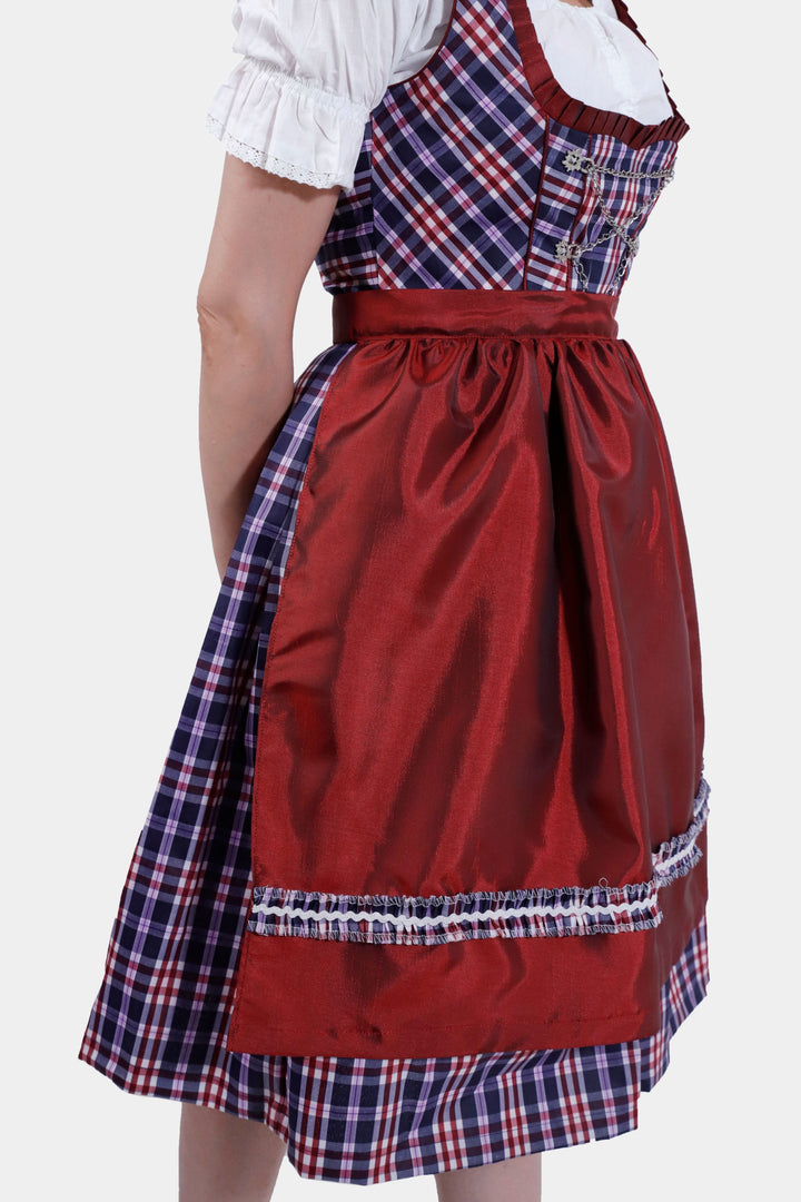 Right Side view of a woman in Dirndl Zsa Inci, emphasizing the plush crimson skirt and decorative apron.