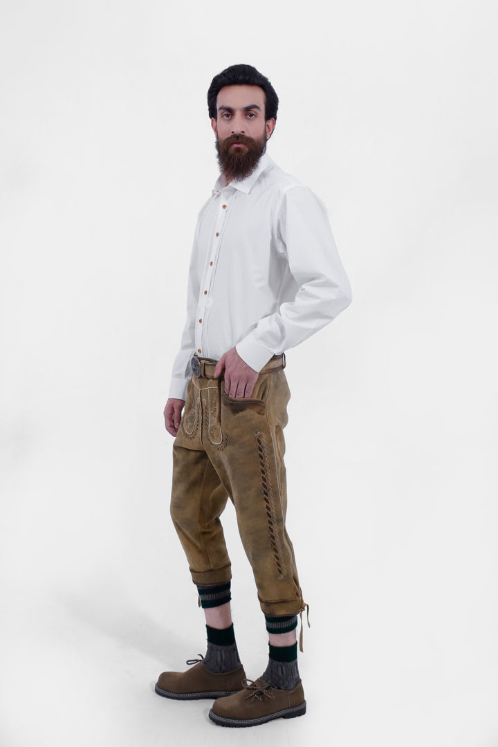  Side view of a man wearing the Edinburgh Castle Bundhosen, showing intricate embroidery, side lace details, traditional socks and brown shoes.