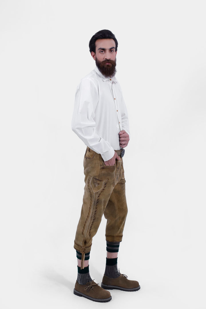  Side view of a man wearing the Edinburgh Castle Bundhosen, showing intricate embroidery, side lace details, traditional socks and brown shoes.