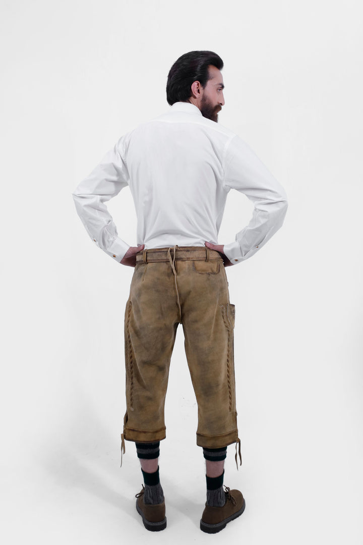  Rear view of a man wearing the Edinburgh Castle Bundhosen, with white shirt showing the back design with traditional socks and brown shoes.