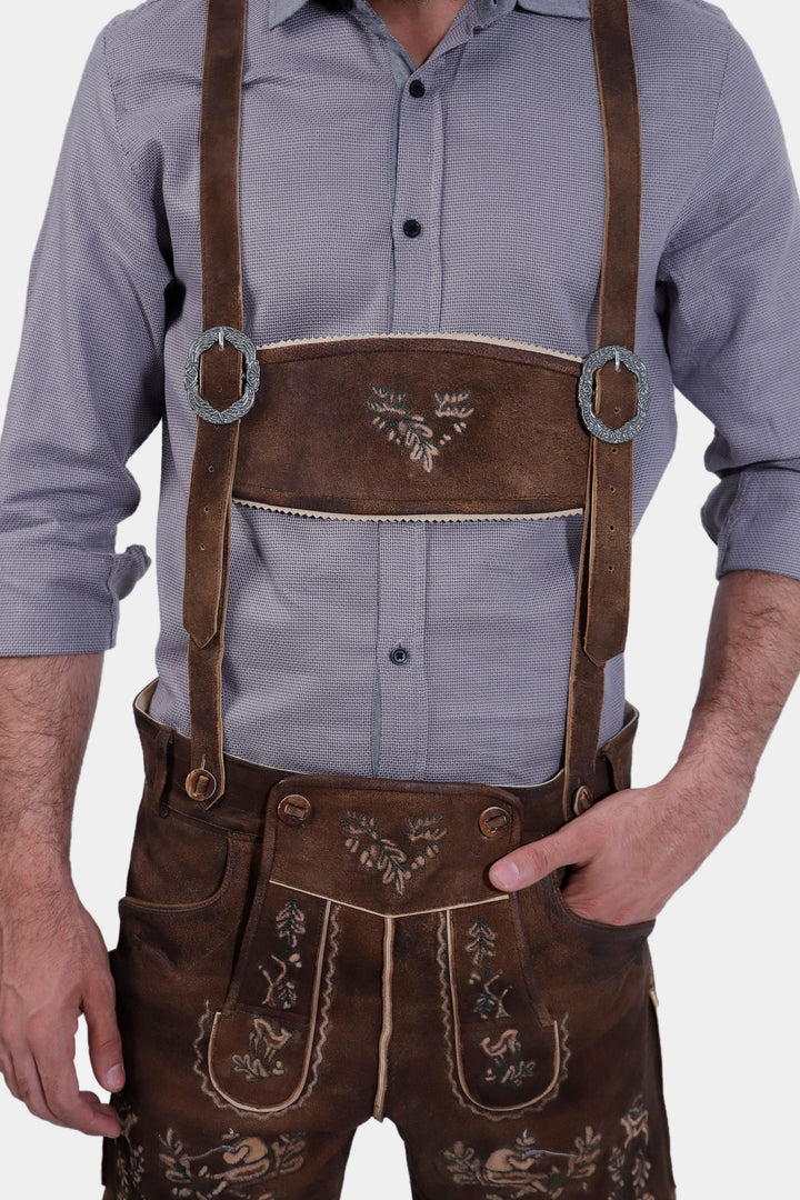 Close-up of Ein Prosit Lederhosen, focusing on the embroidered suspenders and chest area, worn by a man in a grey shirt.