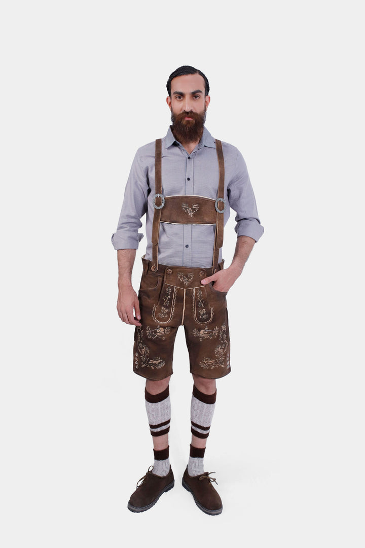 Full-body image of a man wearing Ein Prosit Lederhosen, including suspenders, grey shirt, and knee-high socks, showcasing the complete traditional outfit.