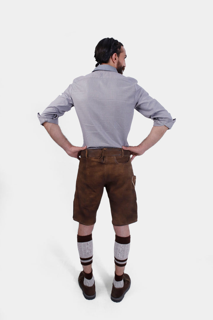 Rear view of a man wearing Ein Prosit Lederhosen, showing the back design of the brown leather shorts and the fit around the waist.