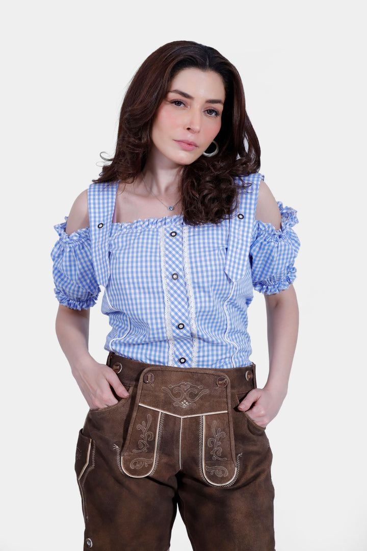 Woman wearing Elsa Lederhosen in a sophisticated pose, showcasing the intricate embroidery and design.