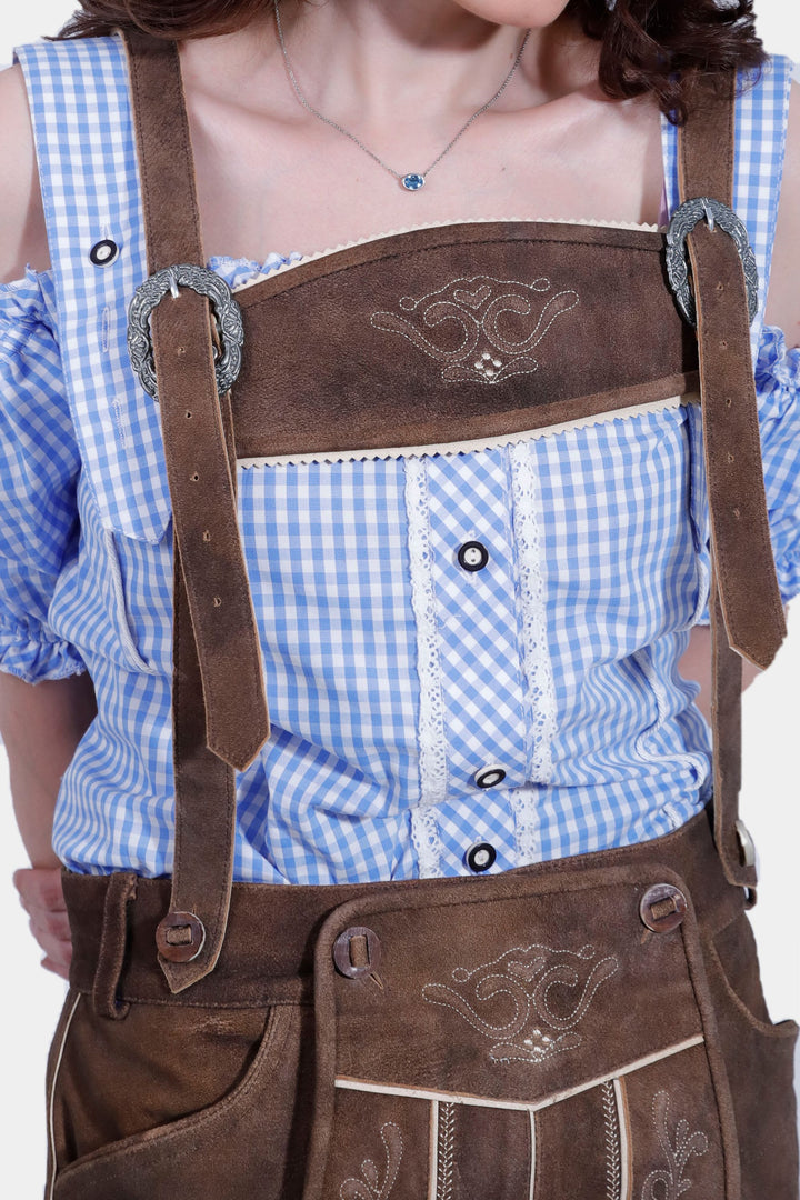 Close-up of the Elsa Lederhosen's embroidered suspenders and buttons.