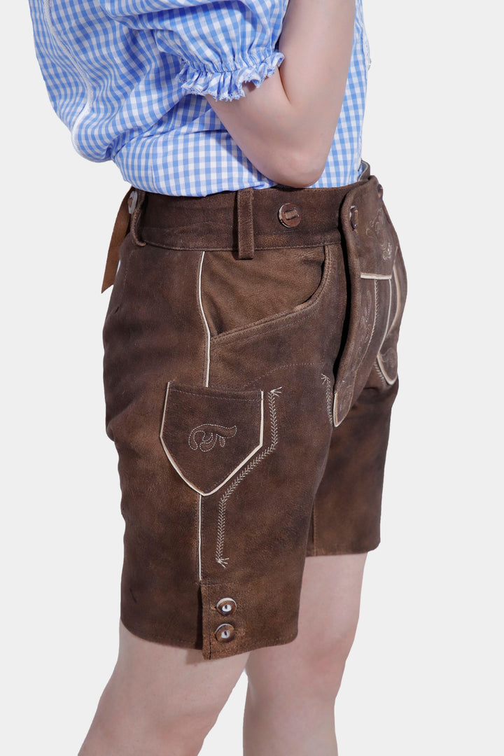 Woman posing in Elsa Lederhosen, exhibiting the traditional Bavarian style with a modern twist.