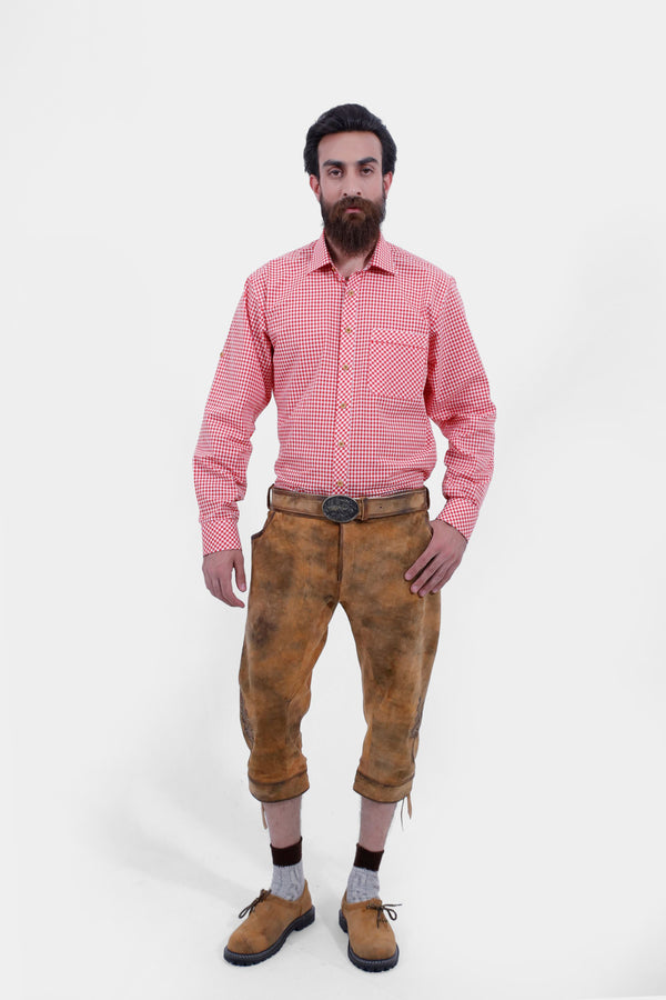 Full view of brown Eltz Bundhosen with red check shirt and brown and grey socks and tan brown shoes, worn by a man against a white background. trachten lederhose kniebund herren​