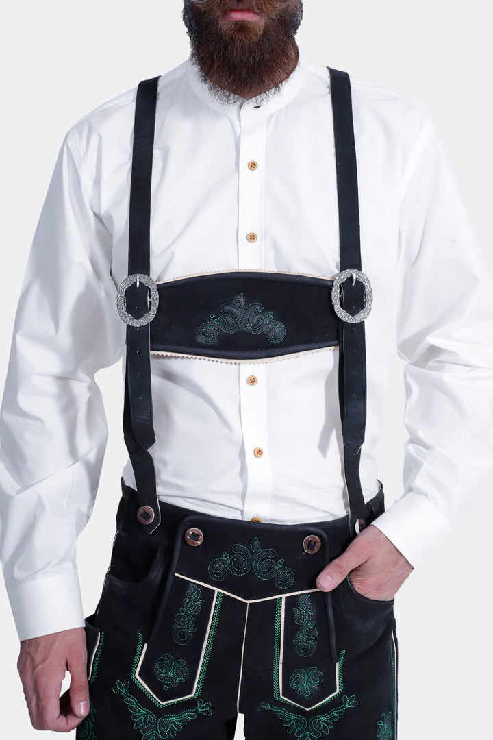 Man in Gropius Lederhosen with black suspenders, featuring green embroidery and traditional buttons.