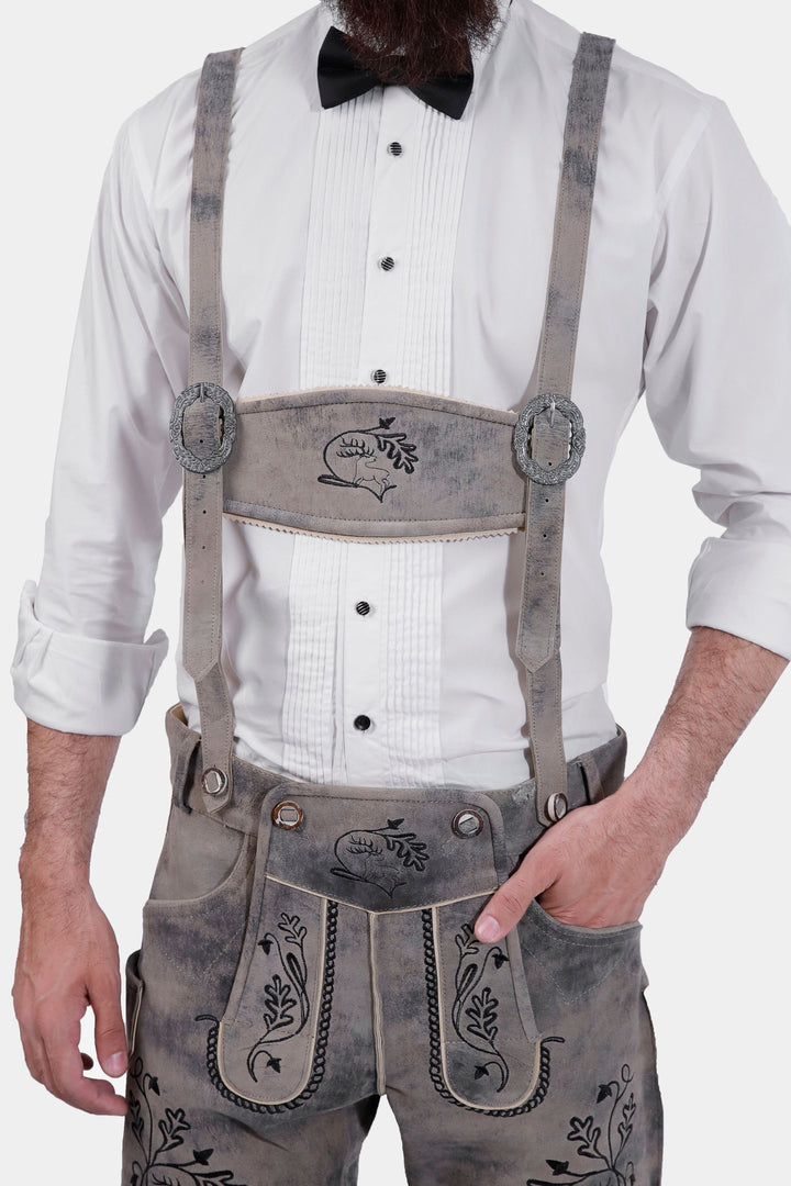 Man in Hofburg Lederhosen with white dress shirt and black bow tie, close-up on chest and lederhosen front.