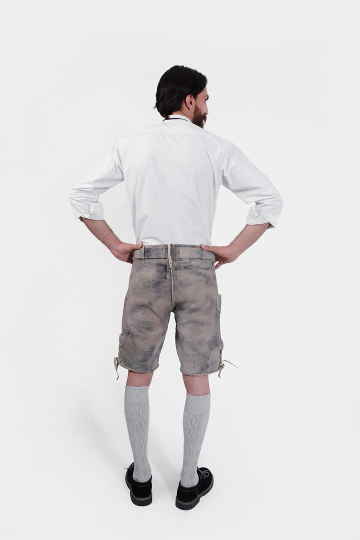 Rear view of man wearing Hofburg Lederhosen, hands on hips, showcasing the back design.