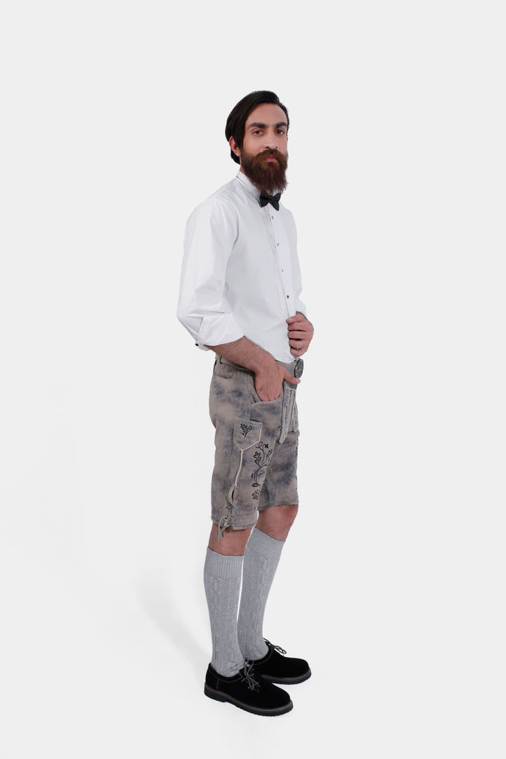 Side profile of man wearing Hofburg Lederhosen with white dress shirt, black bow tie, and gray knee-high socks.