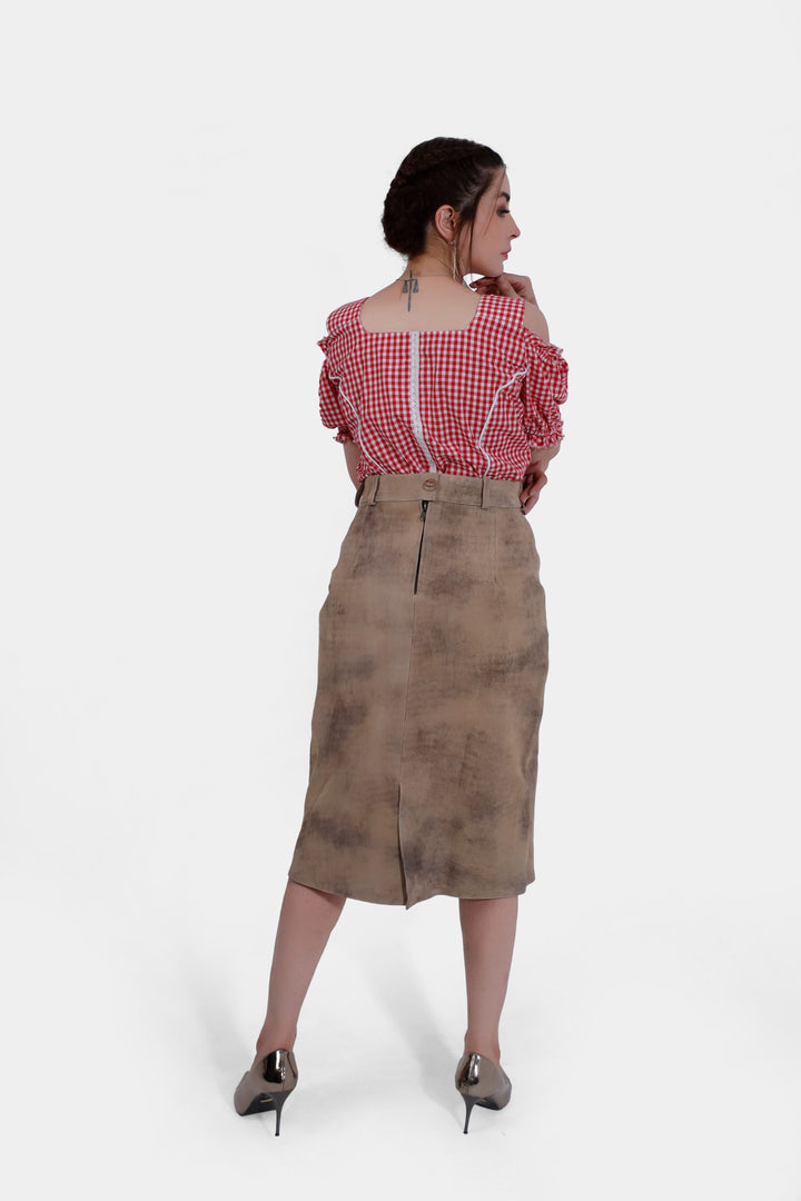 Back view of the Kollwitz Lederhosen Skirt in sandy tan buck skin leather, showing the zipper detail, paired with a red and white checkered blouse.