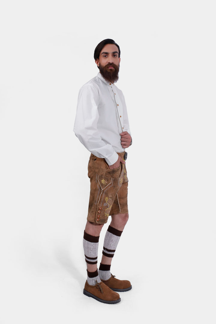 Another side profile of the man wearing Leavenworth lederhosen, showing the intricate details of the embroidery and the fit of the lederhosen.