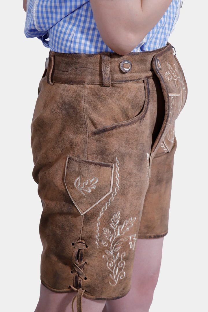 Side view of Lorelei Lederhosen, showing the embroidered side pocket and lace-up detailing.