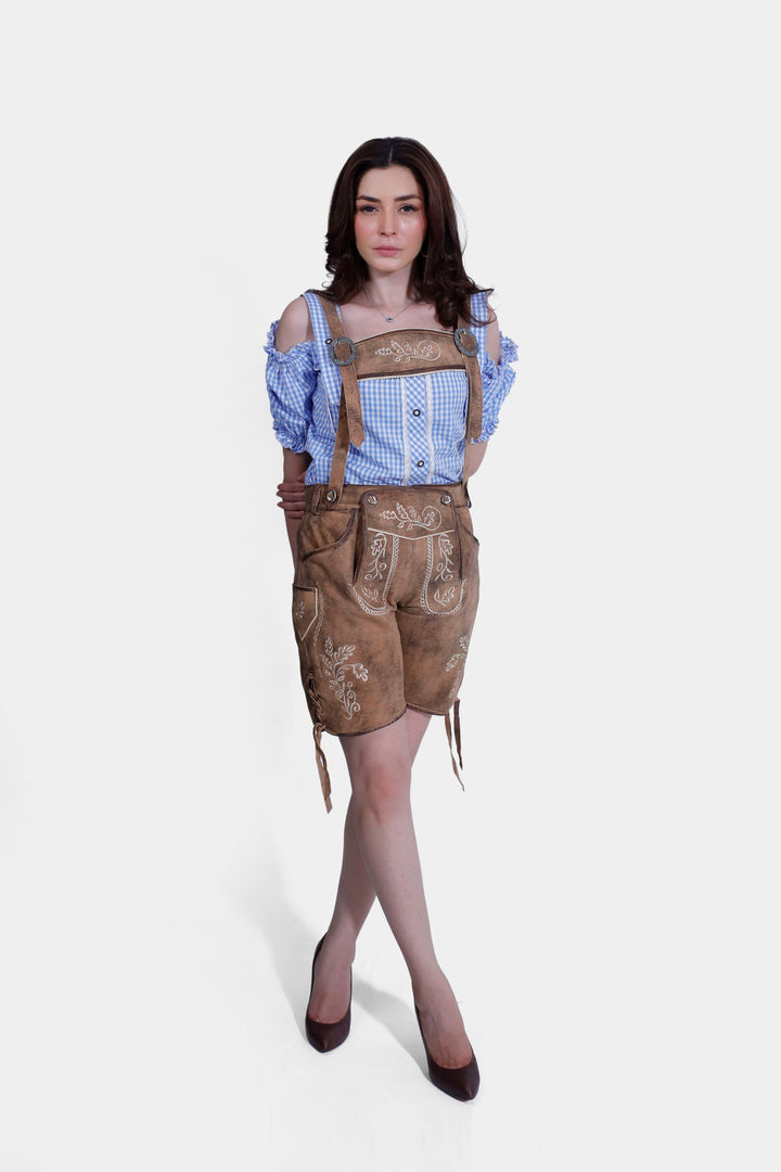 Side view of woman in Lorelei Lederhosen, highlighting the fit and detailed embroidery along the shorts.