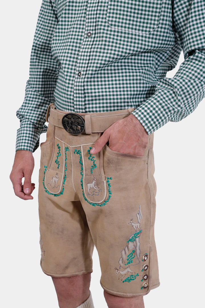 The man wearing the Luther Lederhosen with suspenders attached, showcasing the traditional bib with natural-colored embroidery.