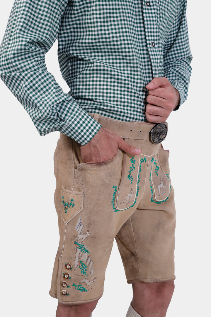  Side view of the man wearing the Luther Lederhosen, displaying the knife pocket and detailed embroidery on the legs.