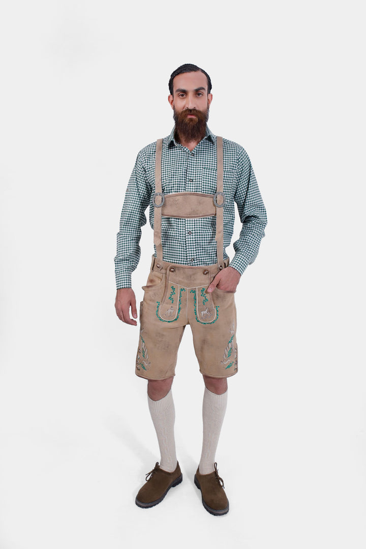 The man wearing the Luther Lederhosen in a full-body view, standing with suspenders, highlighting the overall fit and traditional look.