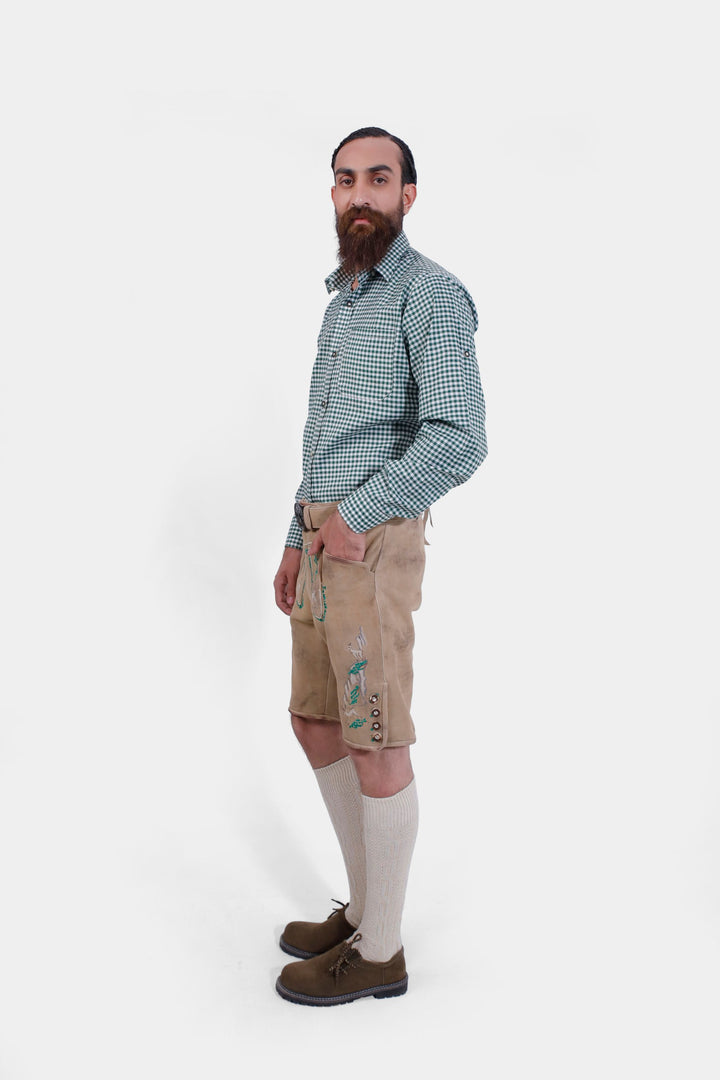 The man wearing the Luther Lederhosen, standing in a side pose, displaying the fit and craftsmanship of the lederhosen.