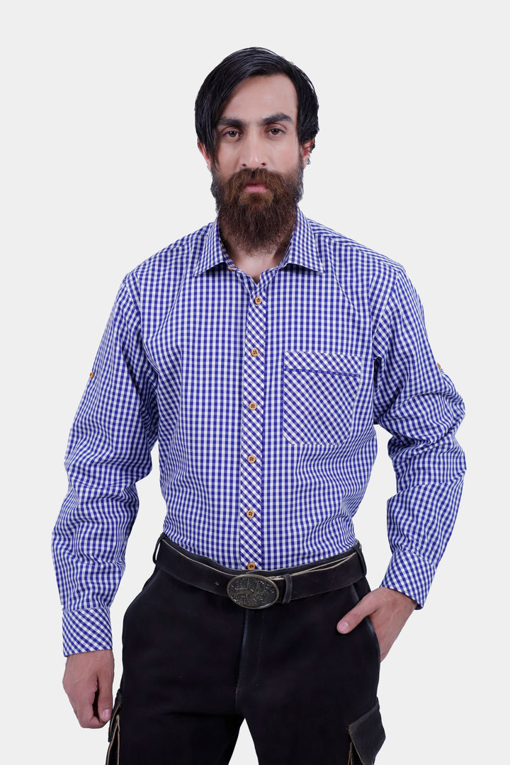 Close-up of a man wearing Manor Oktoberfest Cargo Lederhosen and a blue checkered shirt, showing the detailed design and pockets, along with brown shoes and traditional knee-high socks.