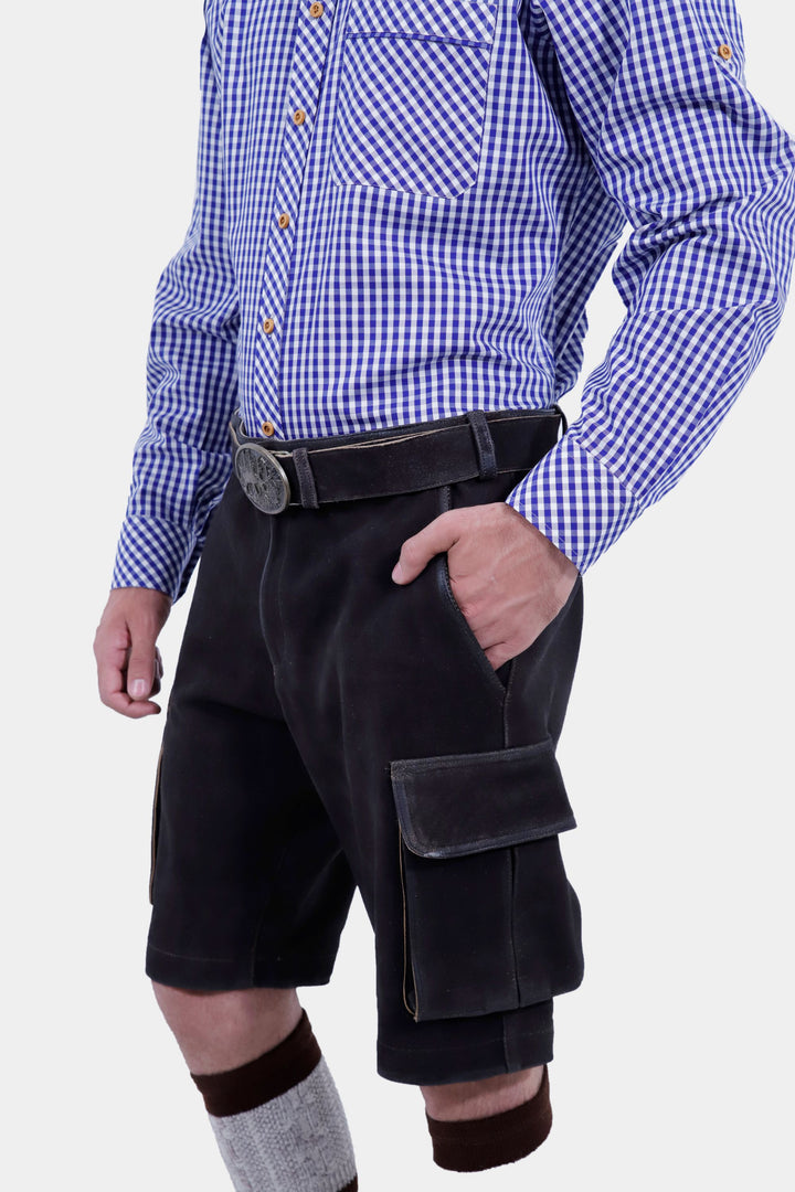 Close-up side view of Manor Oktoberfest Cargo Lederhosen worn by a man, emphasizing the quality leather, pocket details, traditional knee-high socks, and brown shoes.