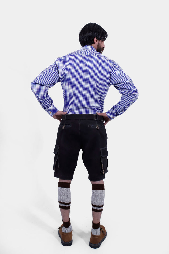 Back view of a man wearing Manor Oktoberfest Cargo Lederhosen, displaying the fit and design from behind, along with brown shoes and knee-high socks.