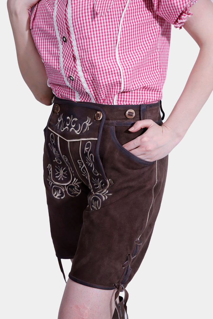 Detailed side view of brown Margarethe Lederhosen featuring white floral stitching and lace-up side details.