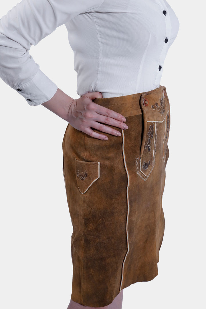 Side view of the Marianna Lederhosen Skirt, showcasing the leather material and the side pocket details.