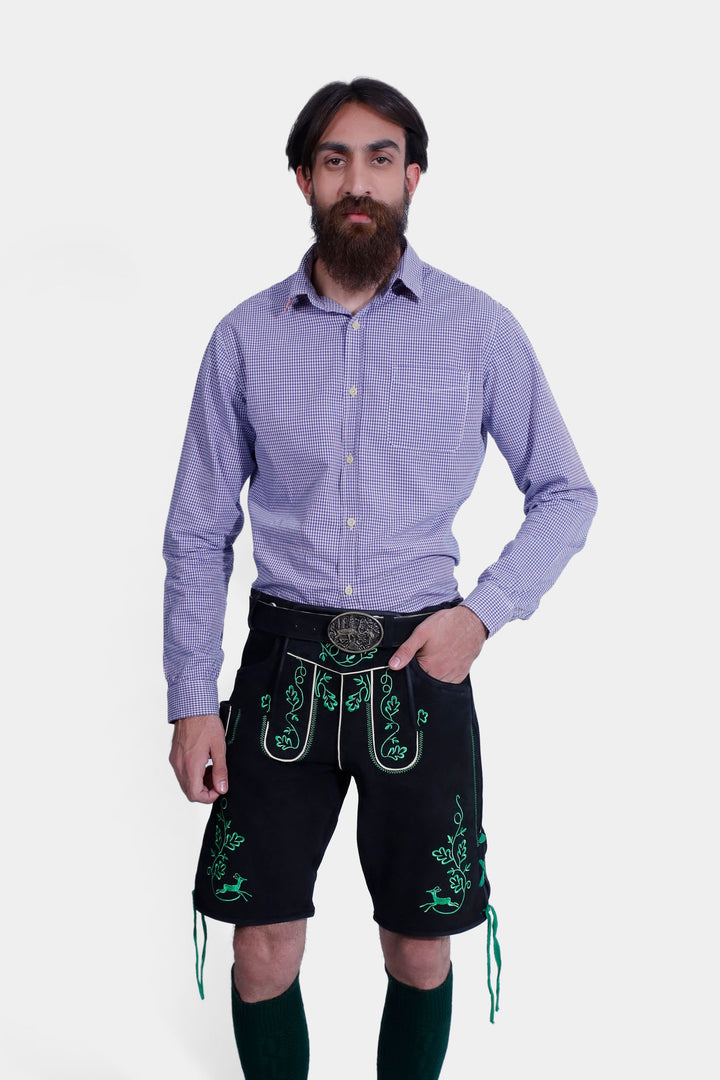 Close-up view of a man in the Melk Abbey Lederhosen Outfit, showcasing the purple checkered shirt and black leather lederhosen with green embroidery and a decorative belt buckle.