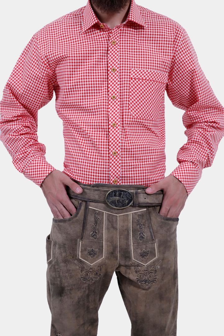 Close-up of a man wearing  Milwaukee Old World  Bundhosen. The focus is on the red checkered shirt and the detailed brown lederhosen with an ornate belt buckle.