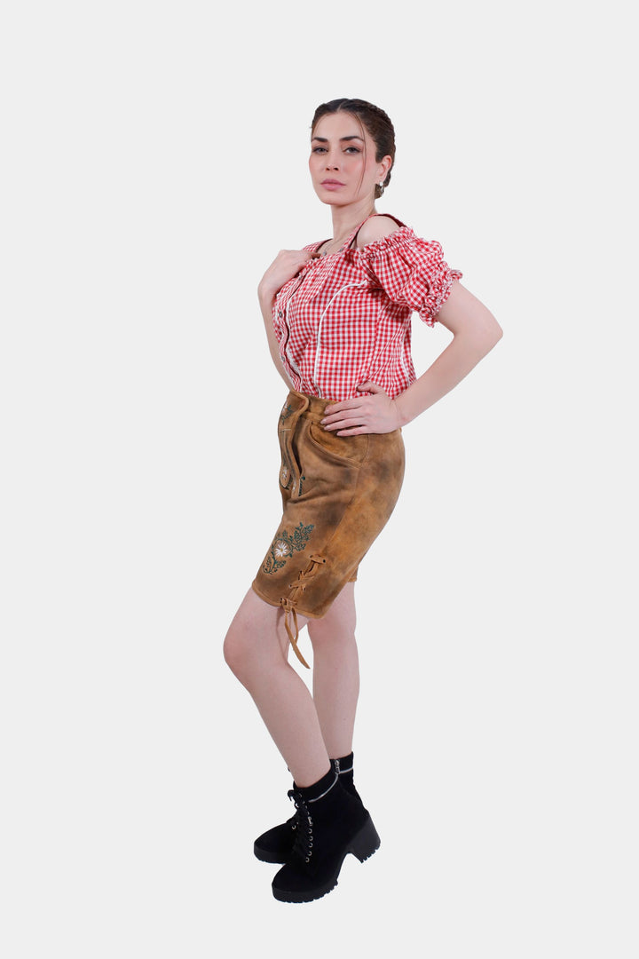 Woman posing in Muncih Majesty lederhosen, accentuating the side embroidery and overall traditional Bavarian style.