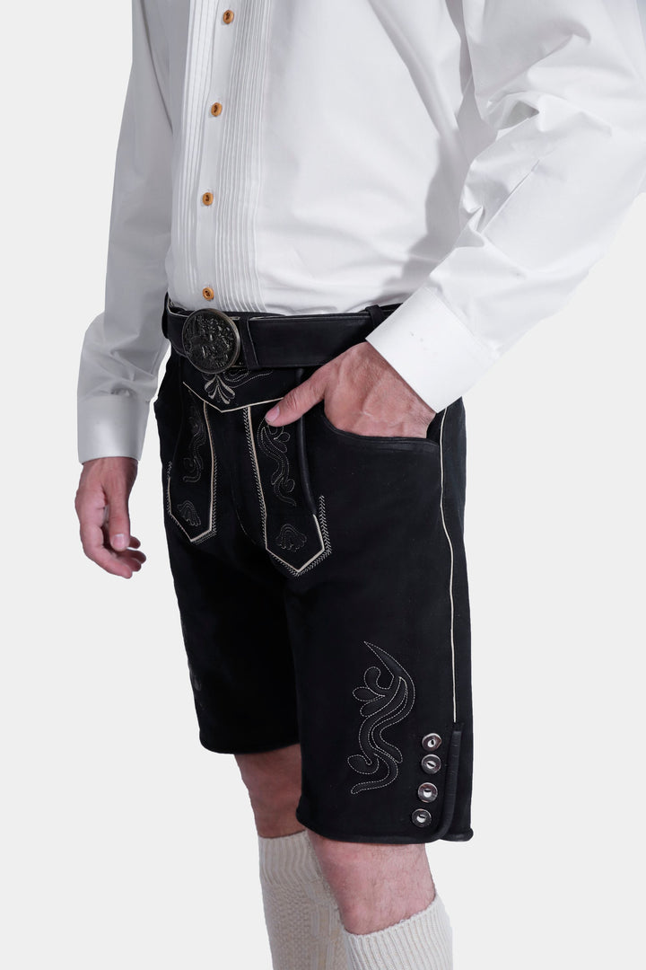 Side profile of a man in traditional attire, showcasing the side knife pocket on black lederhosen.