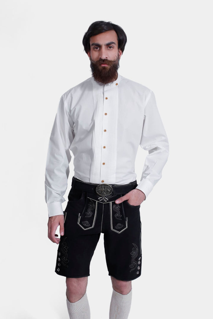 Authentic Oktoberfest clothing, a man models black lederhosen with a luxurious texture and rich embroidery.