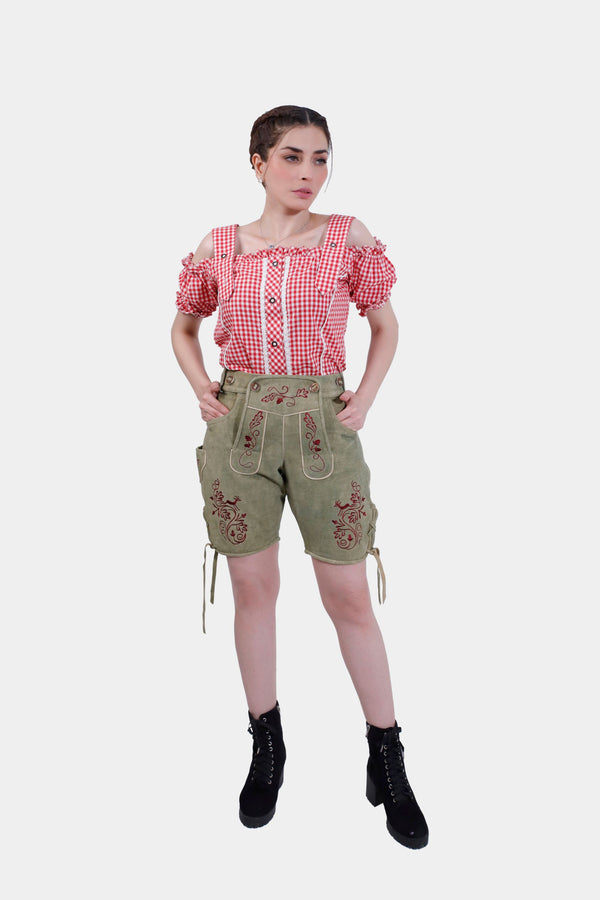 Full front view of a woman in Olivia Charm Lederhosen, showing the entire outfit with the brown horn buttons on the bib and adjustable waistband. Trachten-Lederhosen für Damen