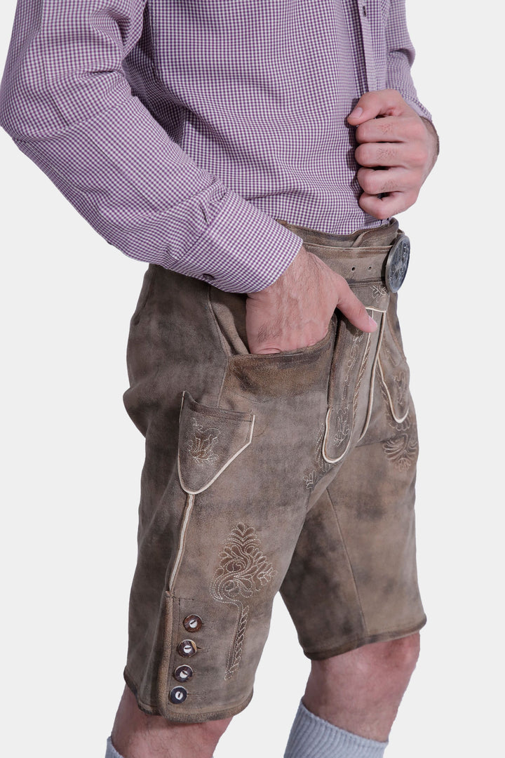 Side view of man wearing Raphael Lederhosen and checkered dress shirt, highlighting the side embroidery.