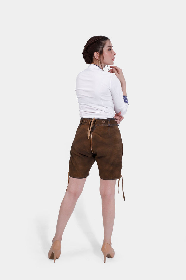 Rear view of a woman in Romy Schneider lederhosen, displaying the back waistband and the overall fit of the shorts.