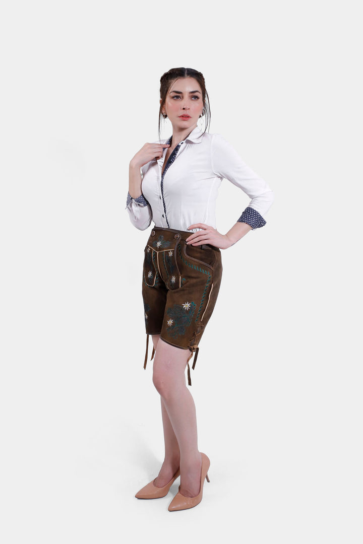 Woman posing in Romy Schneider lederhosen, accentuating the side embroidery and overall traditional Bavarian style.